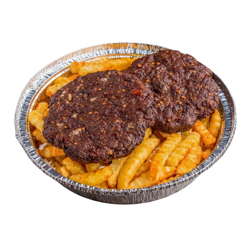 Two spicy dark brown patties on a bed of golden french fries in a foil container.